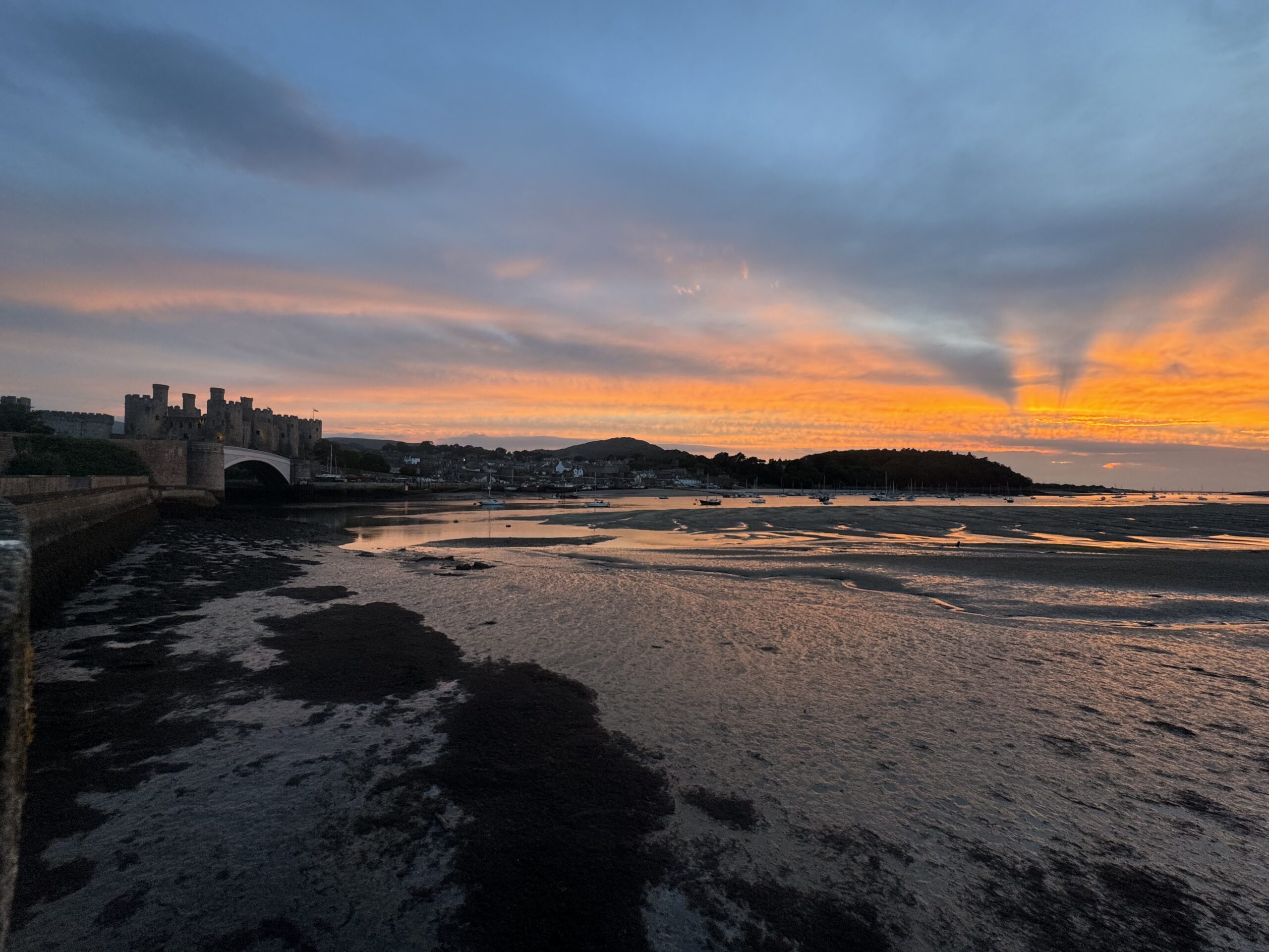 Sunset over the Conwy estuary with the castle in the distance